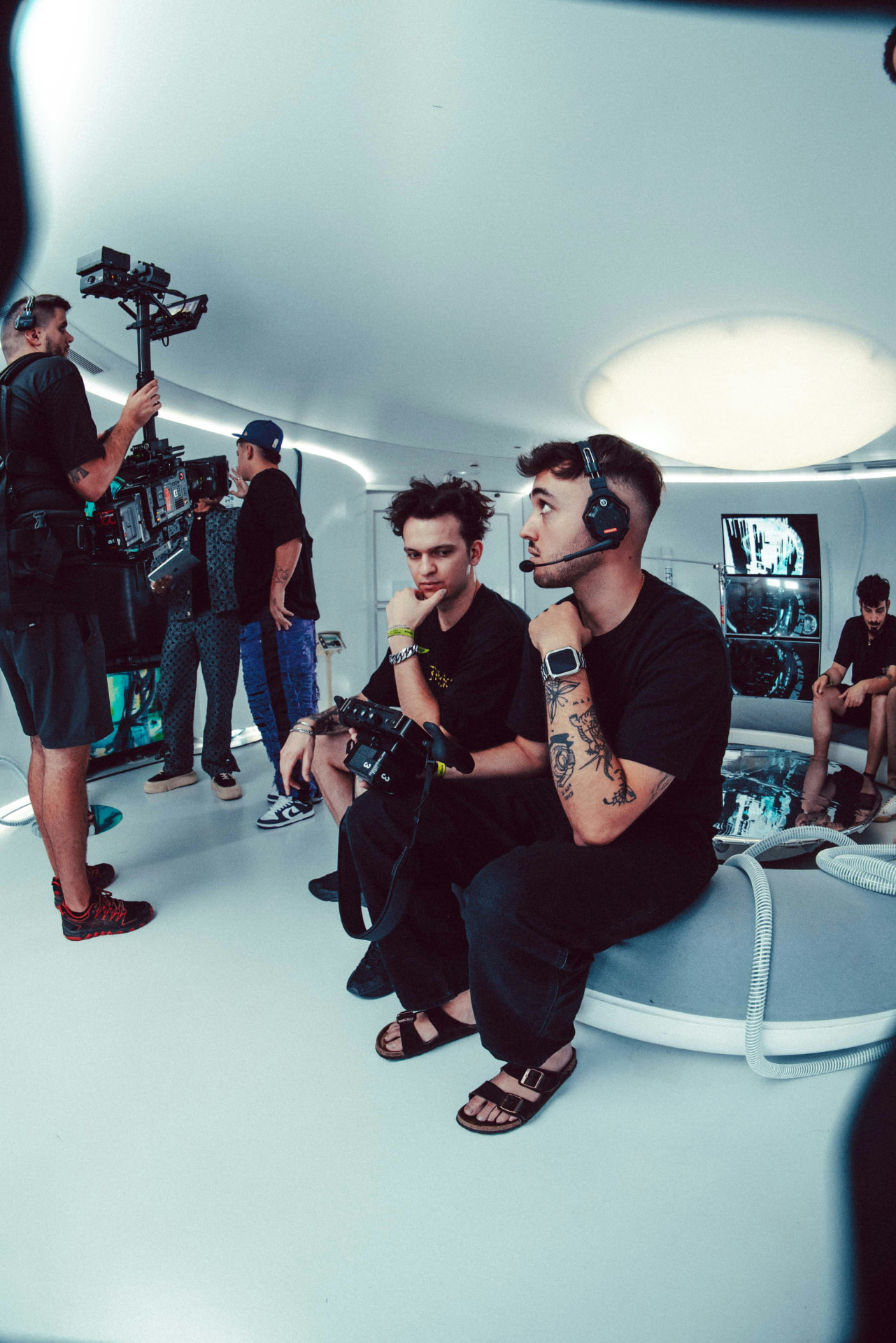 Film crew monitoring a shoot on a documentary set